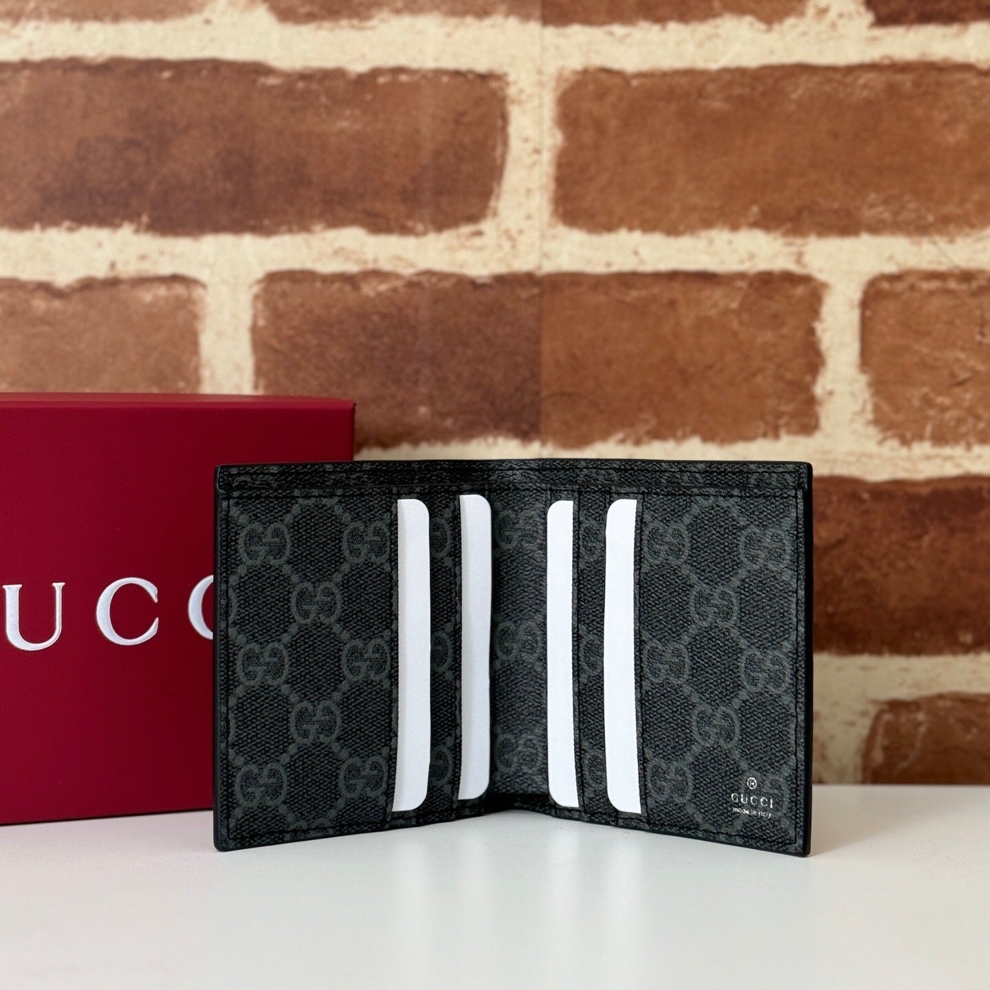 Gucci GG Emblem Bi-Fold Embossed Leather Wallet