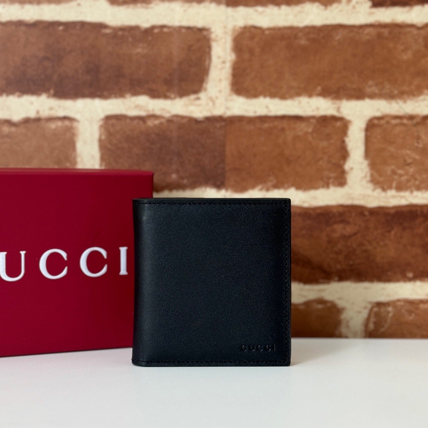 Gucci GG Emblem Bi-Fold Embossed Leather Wallet