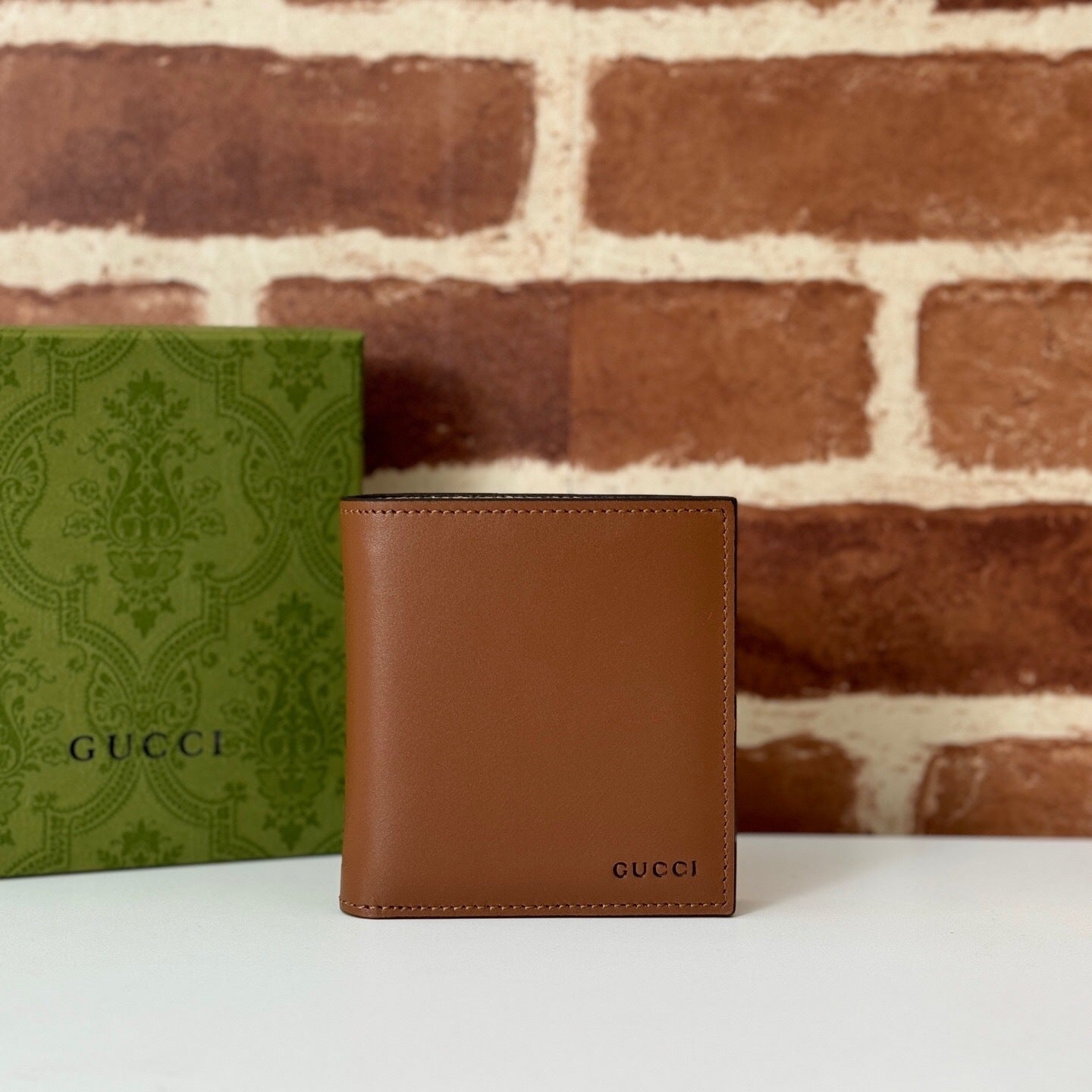 Gucci GG Emblem Bi-Fold Embossed Leather Wallet