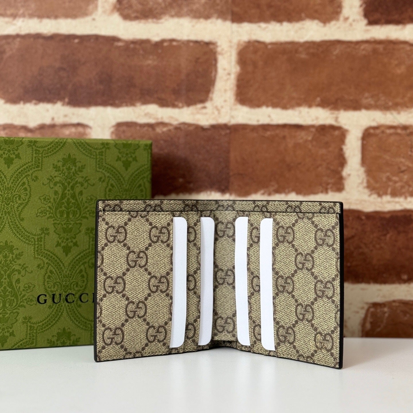 Gucci GG Emblem Bi-Fold Embossed Leather Wallet